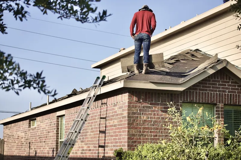 Professional roofer working on a residential roof in Candler Heights